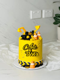 Construction cake in yellow buttercream with toy excavator, front loader, traffic cones and Oreo crumb 'dirt' — CCT thumb 3