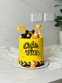 Construction cake in yellow buttercream with toy excavator, front loader, traffic cones and Oreo crumb 'dirt' — CCT Sydney thumb 2