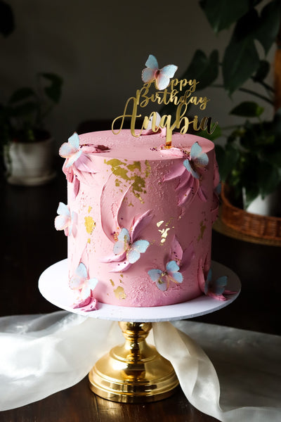 Single tier pink textured buttercream cake with edible butterflies and gold leaf detail