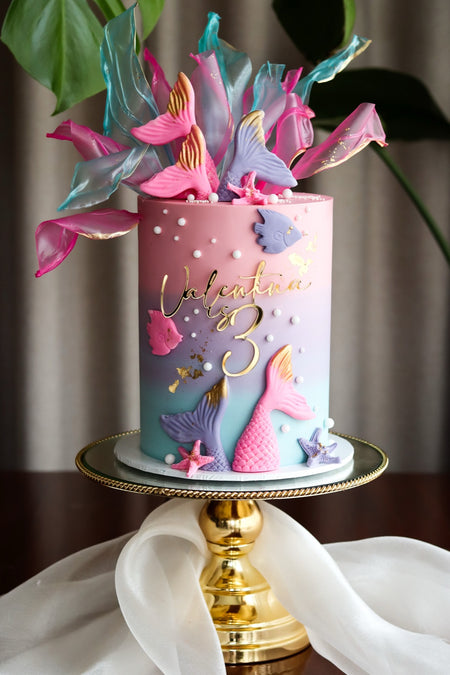 Pastel ombre mermaid birthday cake with sugar tails and seashells