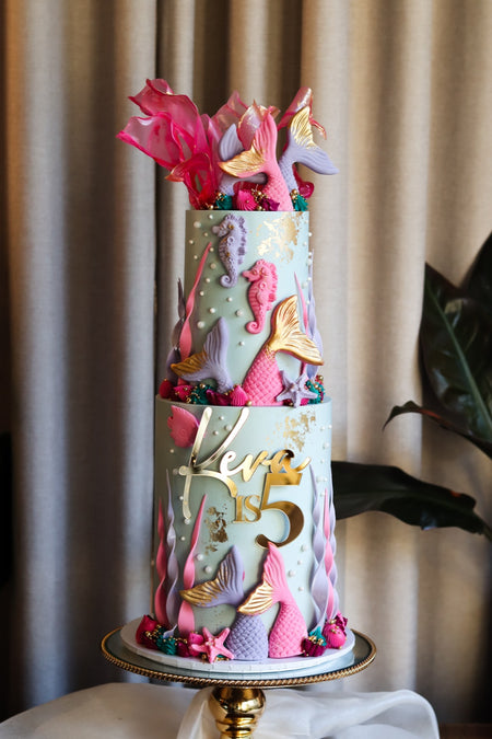 Two-tier under the sea mermaid cake with sugar tails, seahorses and pearls
